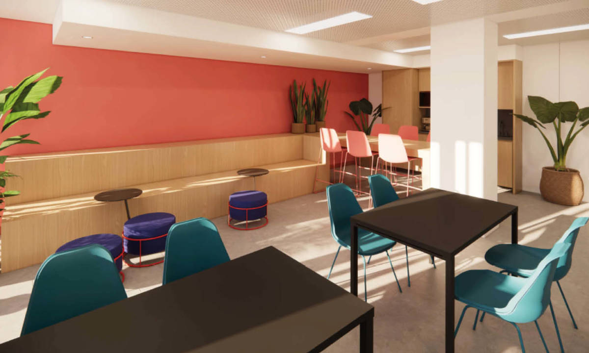 Espacio de coworking abierto con diferentes zonas de trabajo 