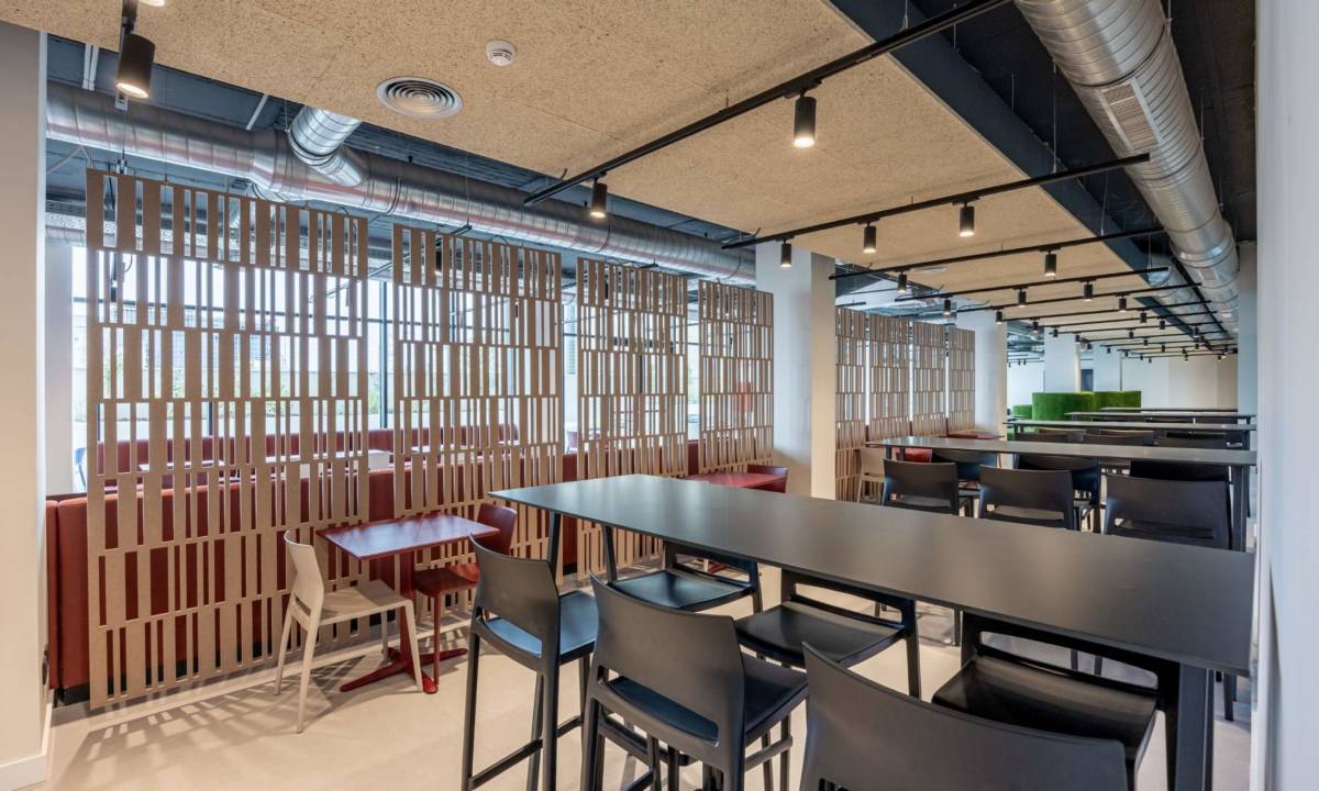 Comedor común de residencia de estudiantes con celosía de madera a medida