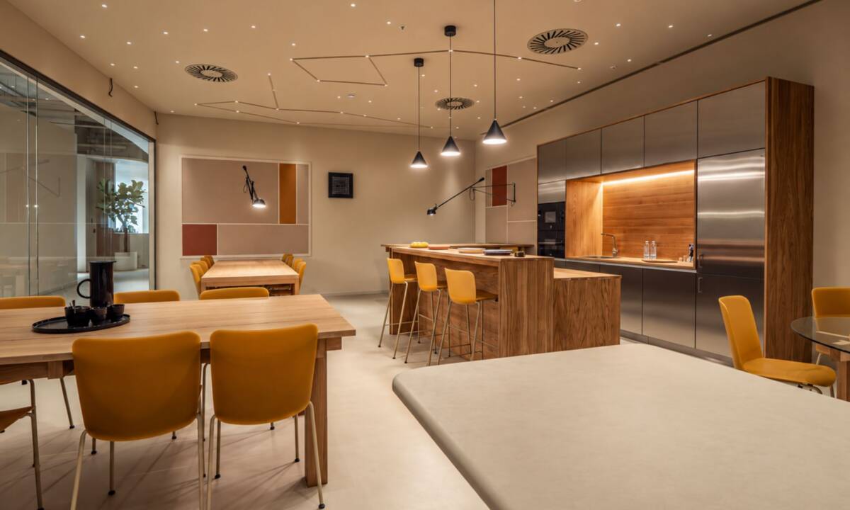 Zona de cantina en oficina con diferentes zonas de descanso, cocina y relax